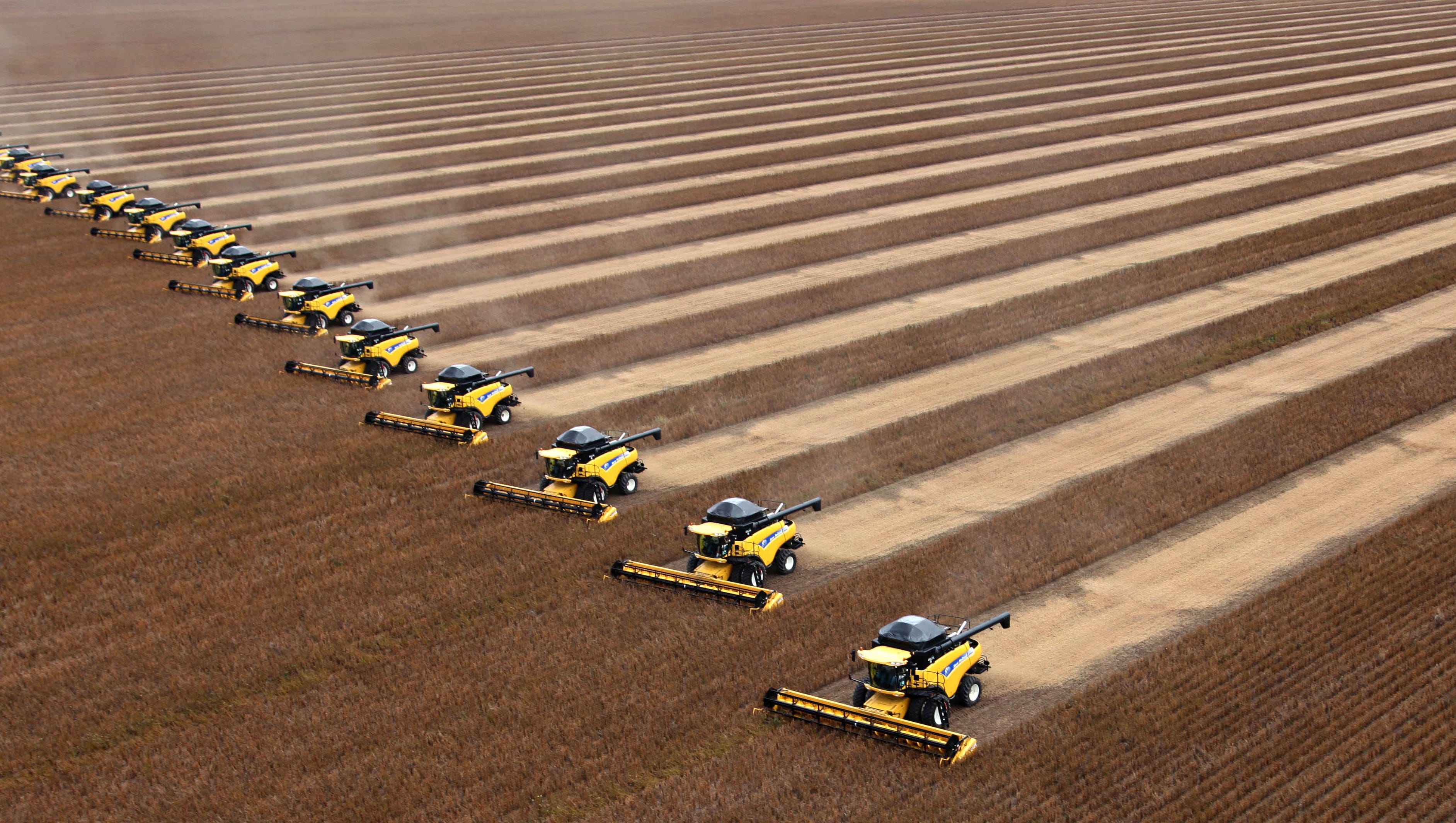 Workers on tractors harvest soybeans in Correntina, northern Brazil. Brazil is the world's largest soy producer, passing the U.S. in May 2020. A continuing drought in South America could impact the country's soybean production.
