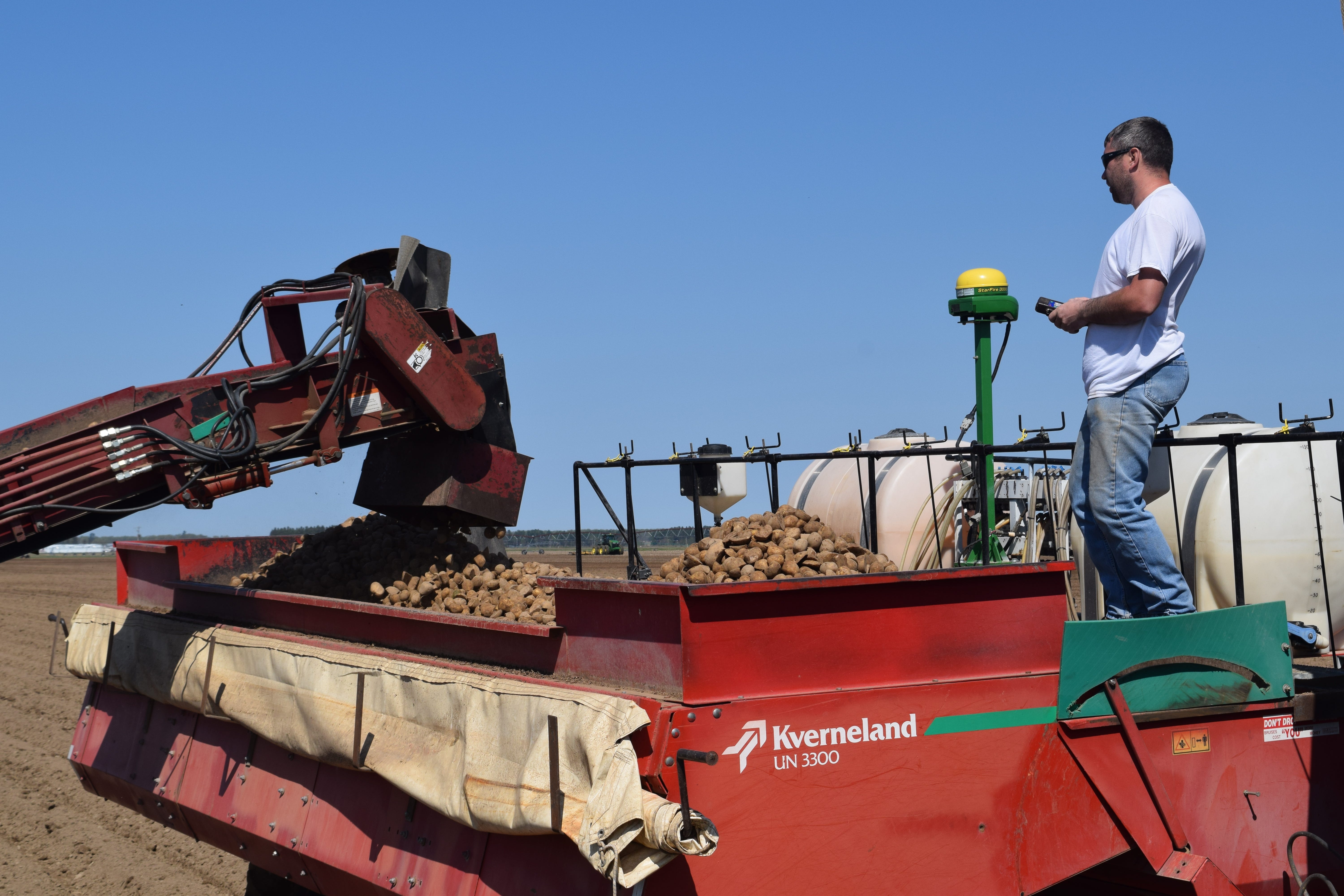 Certified Wisconsin seed potatoes are loaded into a Kverneland UN 3300 planter as Joe Augustine looks on at the Schroeder Brothers Farms, Inc., in Antigo, Wis.