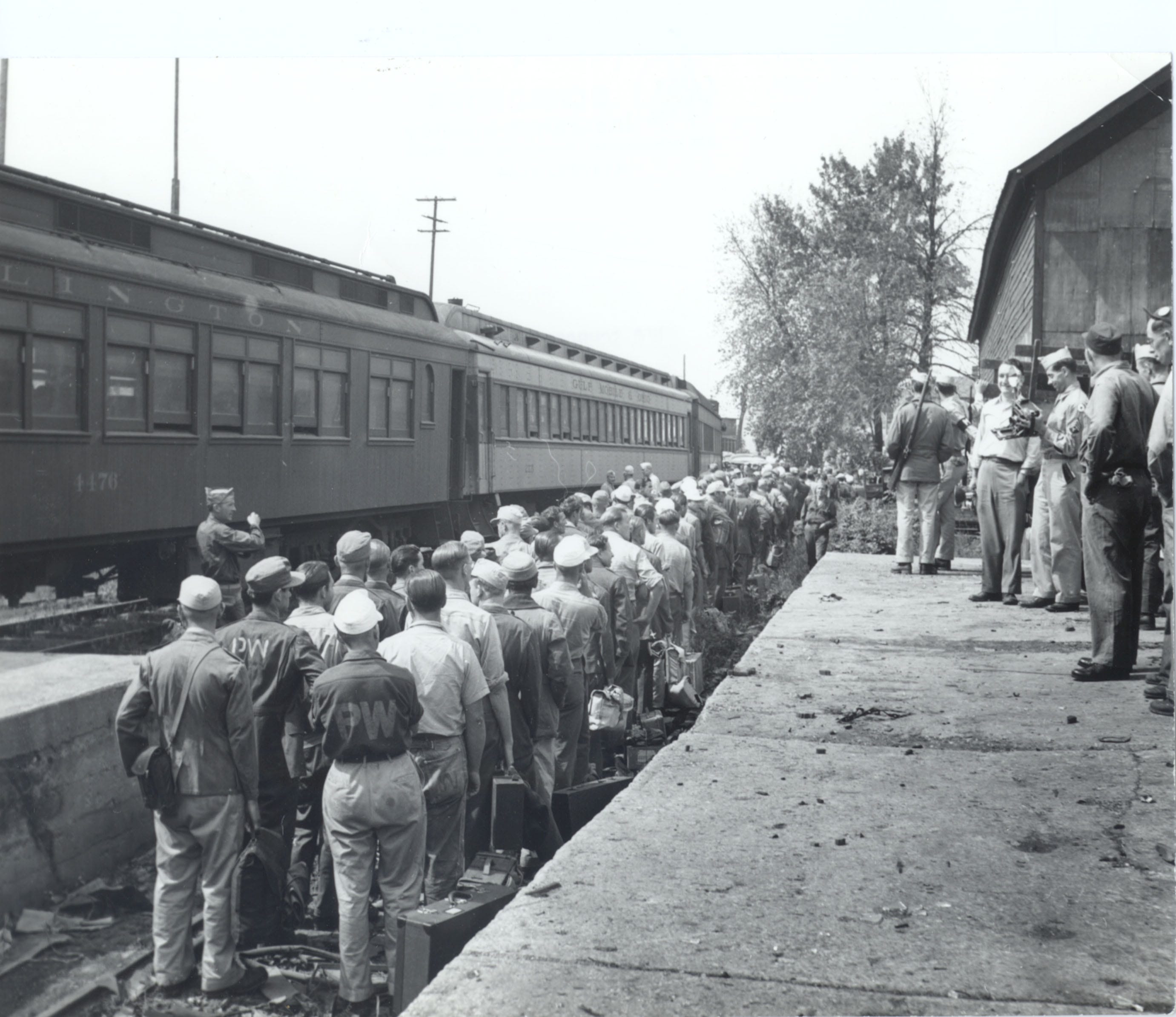 German POWs lined up at a train station in Door County to depart to World War II detention camps. The POWs worked in orchards and canning factories to help supply food to the U.S. during the war years.