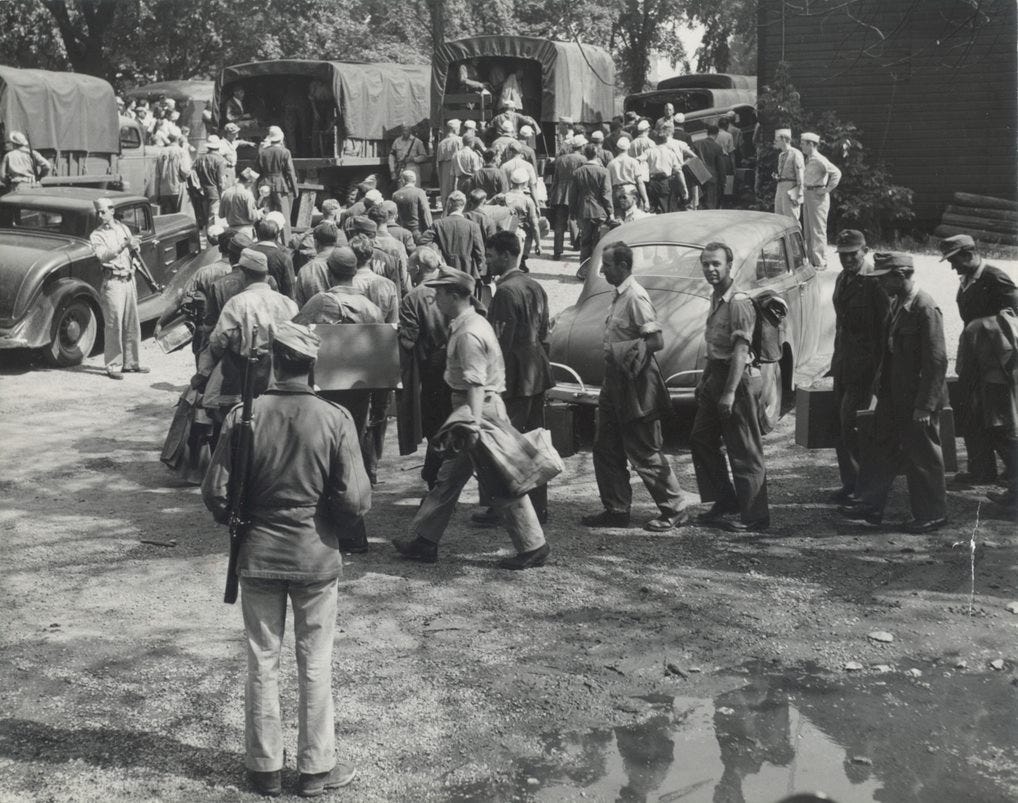 German POWs are loading onto trucks for transport to work in Door County orchards during World War II.