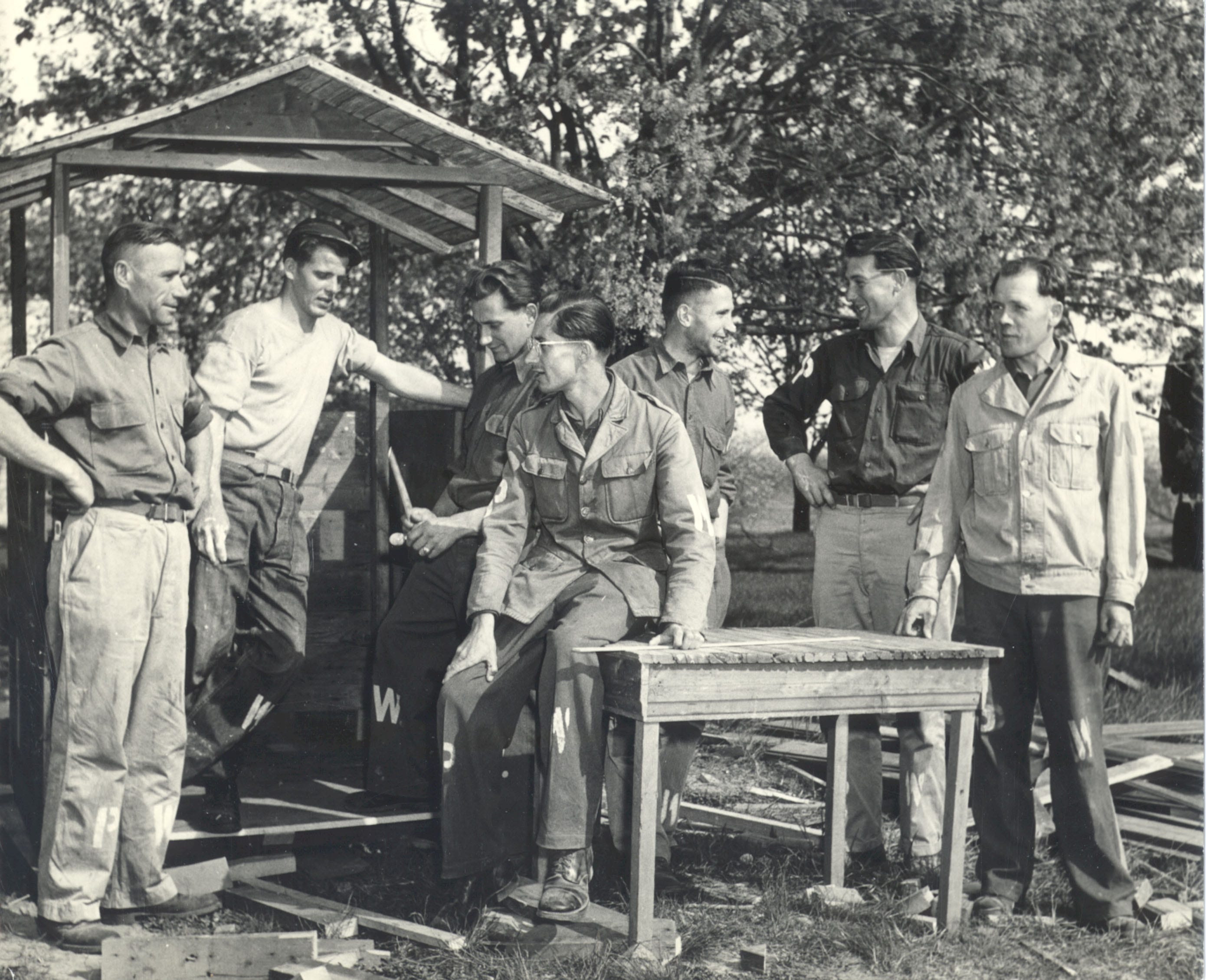 German POWs talking around a table in Door County during World War II. POWs helped harvest cherries and worked in canneries because of a shortage of workers.