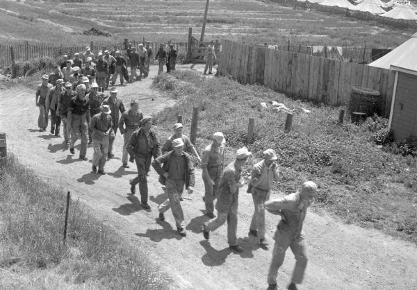 German POWs march to trucks in Columbus to go to work at canning company.